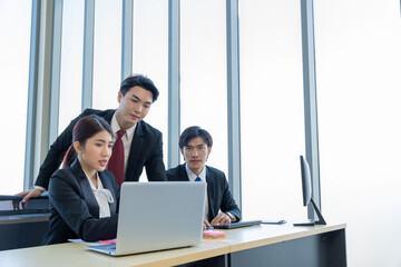 A group of young Asian businessmen Talking and planning work happily and have fun. at the company's office