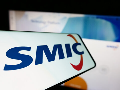 Stuttgart, Germany - 11-30-2022: Smartphone with logo of Semiconductor Manufacturing International Corp. (SMIC) on screen in front of website. Focus on left of phone display.