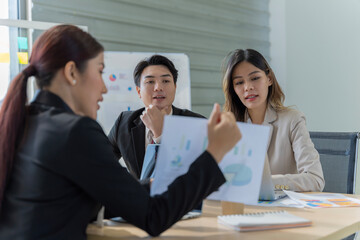 A group of young Asian businessmen Talking and planning work happily and have fun. at the company's office