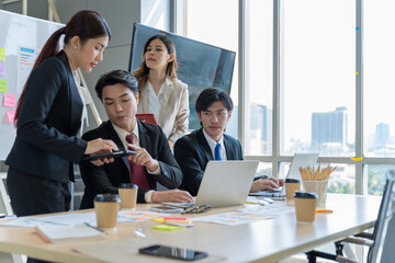 A group of young Asian businessmen Talking and planning work happily and have fun. at the company's office