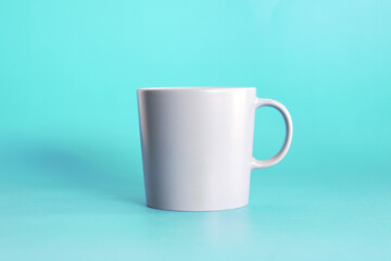 ceramic coffee cup on blue background, drink mug