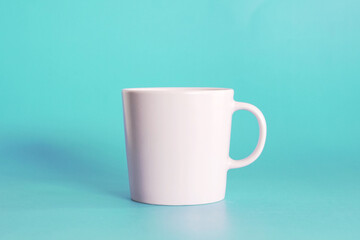 ceramic coffee cup on blue background, drink mug