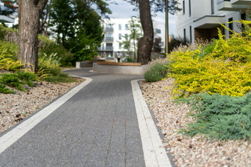 Yard of new apartment building with pedestrian path in private garden