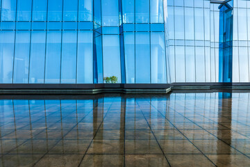 Square floor and glass wall building background with water surface
