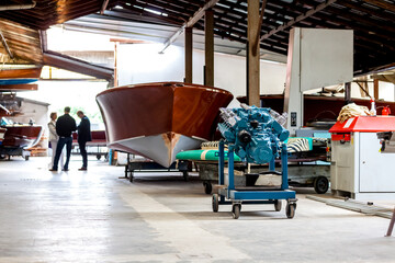 Classic wooden motor boats in shipyard