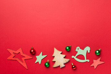 Wooden Christmas toys on color background, top view