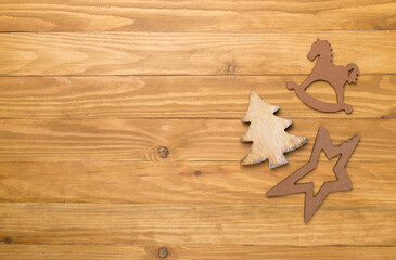 Wooden Christmas toys on wooden background, top view