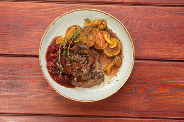 juicy beef steak on plates on a wooden table - restaurant menu