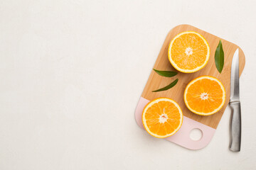 Fresh oranges with leaves on concrete background