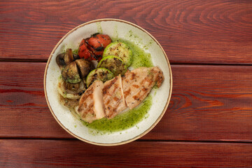 juicy chicken steak on plates on a wooden table - restaurant menu