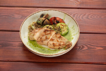 juicy chicken steak on plates on a wooden table - restaurant menu