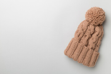 Brown winter hat on color background. Top view