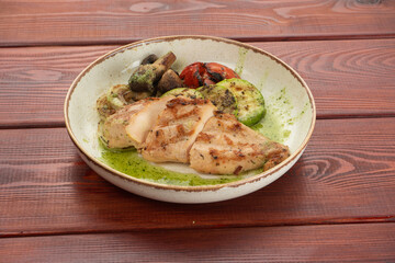 juicy chicken steak on plates on a wooden table - restaurant menu