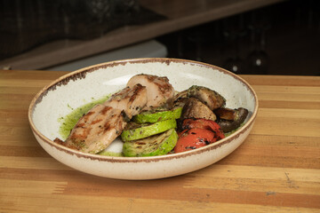 juicy chicken steak on plates on a wooden table - restaurant menu