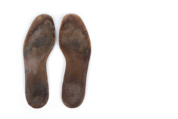 Heavy used insoles on a white background