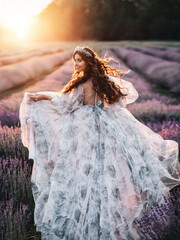Beautiful bride in a lavender field at sunset. The concept of a wedding for two.