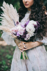 Bride holding gentle wedding bouquet