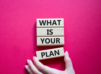 What is your plan symbol. Concept words What is your plan on wooden blocks. Beautiful red background. Businessman hand. Business and What is your plan concept. Copy space