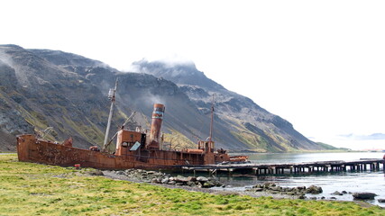 Old, rusted whaling and sealing ship by an old pier at the old whaling station at Grytviken, South Georgia Island