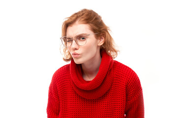 Fototapeta premium Redhead young woman wearing glasses squinting while looking at camera isolated on white background. Vision problems concept