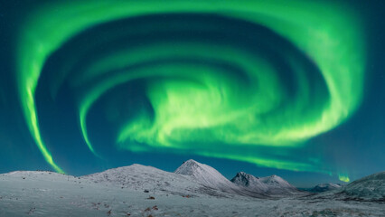 A spiral Aurora Borealis over the Northern Norway near Tromso. High resolution panorama northern lights. High quality photo - 553760419