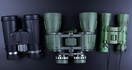 New binoculars isolated on black background. Flat lay, top view