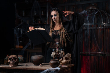 Fototapeta na wymiar Witch in dark use spell book