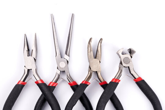Set of different types of pliers and side cutters isolated on white background. Hand tools for repair, construction and maintenance