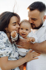 Happy young family spend time together outside in green nature