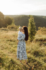 Happy young family spend time together outside in green nature