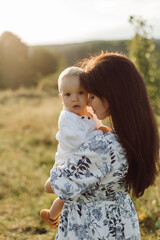 Happy young family spend time together outside in green nature