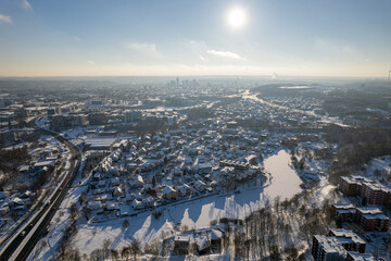 Aerial winter snowy day view of forest in Vilnius, Lithuania