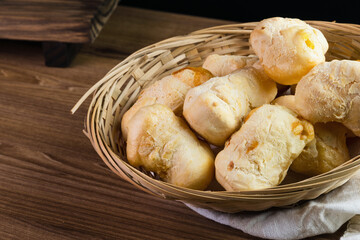 Brazilian Pão de queijo, fresh cheese breads on rustic wood. Selective focus