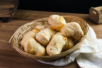 Brazilian Pão de queijo, fresh cheese breads on rustic wood. Selective focus
