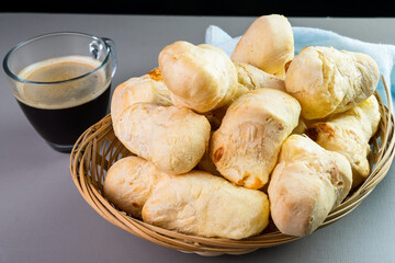 Brazilian Pão de queijo, fresh cheese breads and a hot cup of coffee. Selective focus