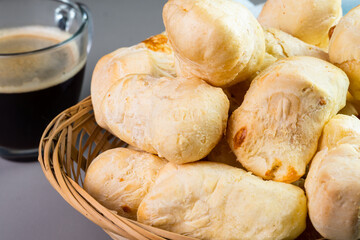 Brazilian Pão de queijo, fresh cheese breads and a hot cup of coffee. Selective focus