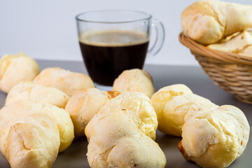 Brazilian Pão de queijo, fresh cheese breads and a hot cup of coffee. Selective focus