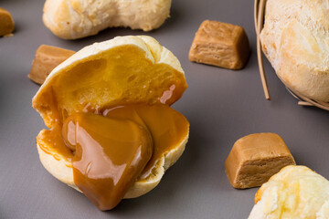 Brazilian Pão de queijo, fresh cheese bread stuffed with dulce de leche. Selective focus
