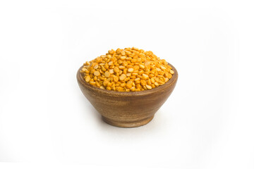 Split Chickpea Also Know as Chana Dal, Bright yellow dried chickpea lentils in wooden bowl on white background