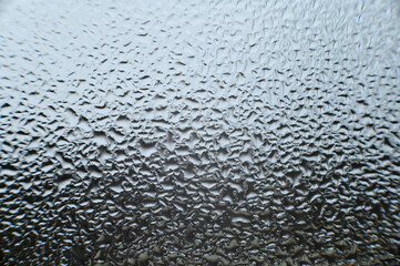large dew drops on the window after condensation has settled on the window.