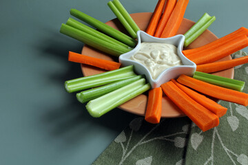 Crudités: celery and carrot sticks with creamy ranch dip. - obrazy, fototapety, plakaty