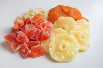 Pile of different dried fruits on white background