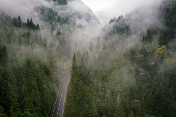 Bicaz pass mountain road high up in the Carpathian Mountains in Romania on a foggy autumn day
