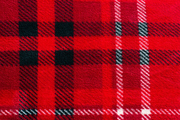 Red plaid in a cage. Texture of plush fabric. Cells. Christmas.