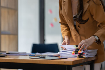 Boring young business Asian woman holding document file and work at office investment data report Financial and tax systems concept.