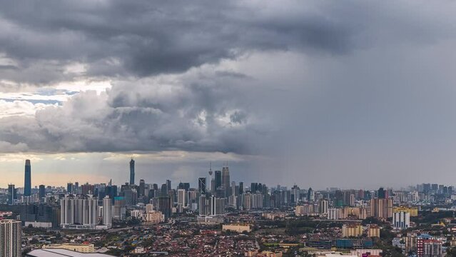 Monsoon cityscape time lapse with Dark clouds rain curtains and busy expressway against the Kuala Lumpur city skyline at sunset from afar in Malaysia. Prores 4KUHD Timelapse.