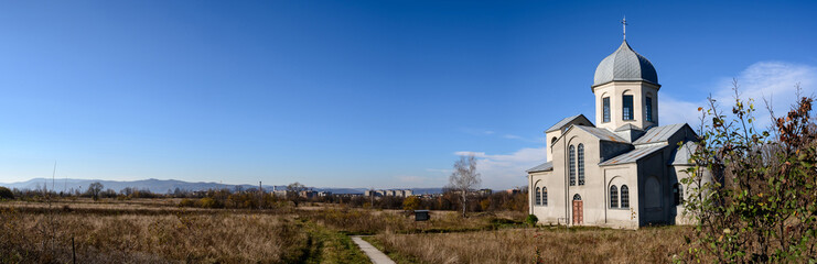 Fototapeta na wymiar The church of the young generation on the horizon, a panorama of the autumn landscape.
