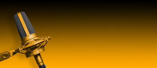 Professional yellow microphone for podcast or broadcast banner. Audio content background with copy...