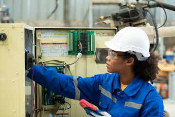 Experienced female electrical engineer The electrical system of the welding robot's electrical...