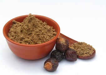 Sapindus mukorossi or Indian soapberry powder in a bowl 